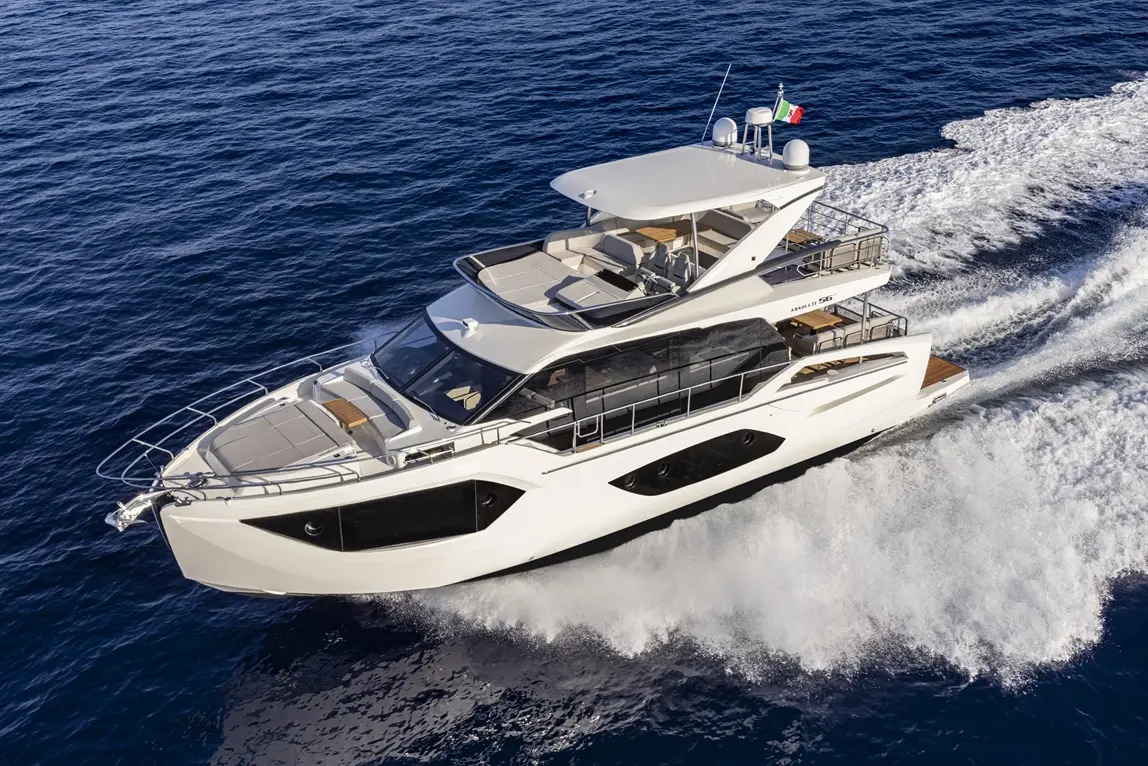 A luxury motor yacht cruising through deep blue waters, displaying Italian flag and stylish deck features.